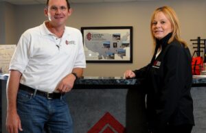 Central States Manufacturing CEO Rick Carpenter, left, and Presidents  Donna Leger stand in the main lobby of their office in Lowell.