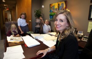 Julia Strickland, business manager for Cross Gunter Witherspoon & Galchus, at work at the Little Rock law firm with her children Katie, 12; Will, 10; and Erin, 7.