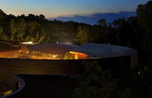 Crystal Bridges Museum of American Art at night. The museum is renowned for its grounds and architecture as well as its collection.
