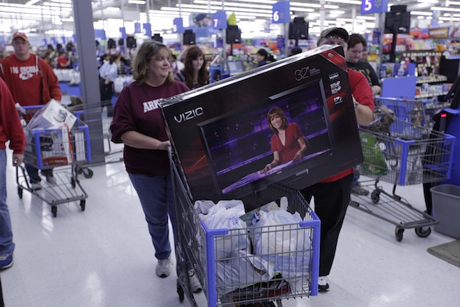 Shoppers at a Wal-Mart in Bentonville snatch up flat-screen televisions during Black Friday 2011.