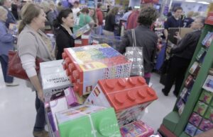 Shoppers at a Wal-Mart store in Bentonville stand in line during Black Friday in 2011. The retailer plans to open at 8 p.m. on Thanksgiving Day this year.