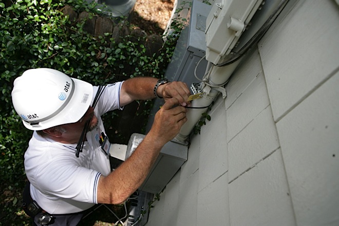 A technician installs&nbsp;AT&T's U-Verse service at a home.