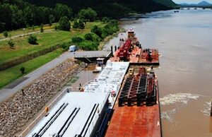 The Corps signs an agreement with the Arkansas-Oklahoma Port Operators Association to ensure the viability of the McClellan-Kerr Arkansas River Navigation System, which allows barges like this one to ship goods on the river.