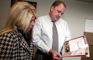 File photo of Chris Wyrick, right, in 2010, when he was senior associate athletic director and executive director of RSVP, talking with Megan Lomax, assistant director for RSVP.
