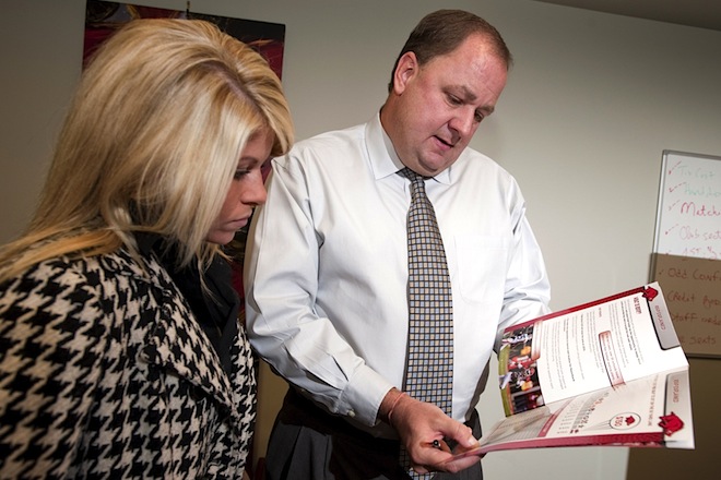 File photo of Chris Wyrick, right, in 2010, when he was senior associate athletic director and executive director of RSVP, talking with Megan Lomax, assistant director for RSVP.