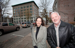 Anne Laidlaw, director of Arkansas Building Authority, and Dan McDonald,&nbsp; administrator of the state Office of Child Support Enforcement, pose with the Mann on Main.