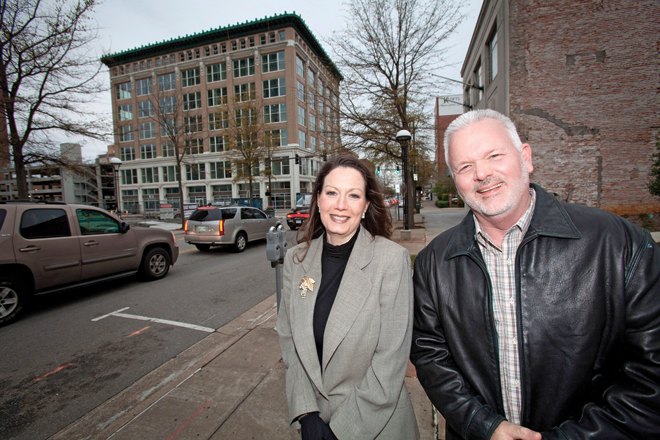 Anne Laidlaw, director of Arkansas Building Authority, and Dan McDonald,&nbsp; administrator of the state Office of Child Support Enforcement, pose with the Mann on Main.