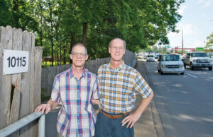Brothers Mike and David Arnold stand in the driveway of the family&rsquo;s once rural homestead that fronts on Rodney Parham Road. Their land is part of a proposed Kum & Go site.