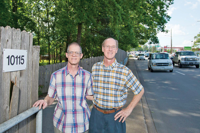 Brothers Mike and David Arnold stand in the driveway of the family&rsquo;s once rural homestead that fronts on Rodney Parham Road. Their land is part of a proposed Kum & Go site.