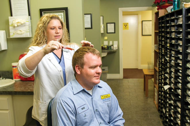 Brittany Jordan of the Arkansas Occupational Health Clinic takes a hair sample for J.B. Hunt&rsquo;s drug screening program.