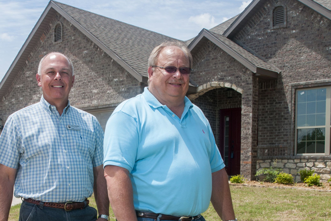 Ron Pender, left, and Barry Cooksey are building houses in the Clower Farms neighborhood in Rogers and on other OREO lots acquired from Benton County lenders. Banks are working to convert into cash property recovered on failed development loans.