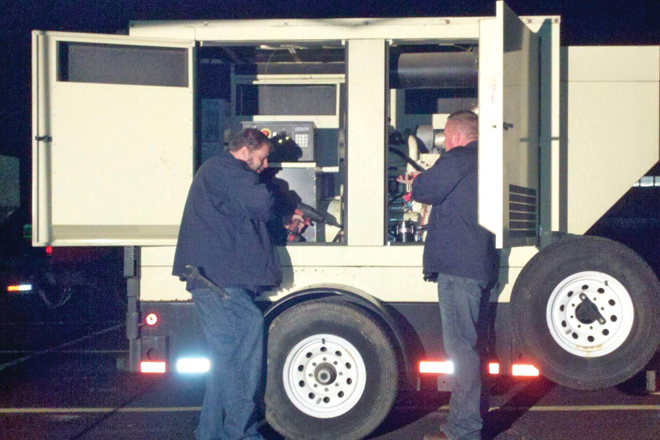 Raymond Biehslich, a senior portable generator technician, works with Shane Young, president of Service Ninjas.&nbsp;