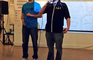 Startup Weeekend NWA organizers Jordan Carlisle (left) and Max Farrell announce the event's winners Sunday in Fayetteville.