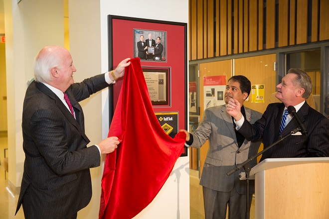 NanoMech CEO Jim Phillips, NanoMech founder Ajay Malshe and UA Chancellor David Gearhart unveil a plaque recognizing the company&rsquo;s R&D 100 award in 2013.