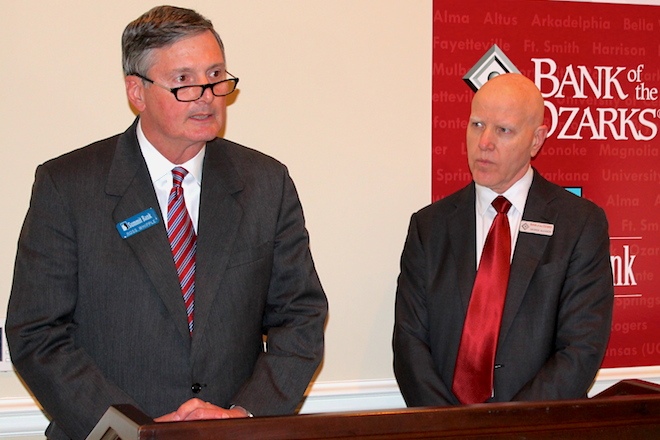 Ross Whipple, left, chairman and CEO of Summit Bancorp. of Arkadelphia, and George Gleason, chairman and CEO of Bank of the Ozarks of Little Rock, speak at a news conference detailing Bank of the Ozark's $216 million deal to buy Summit.