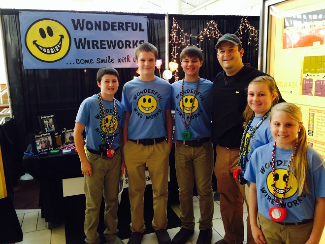 Little Rock orthodontist Andy Vondran poses with Wonderful Wire Works team members at the 2014 YES student business-plan competition. (Photo by Wendy Perry)