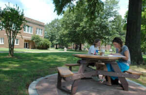 A pair of students study outside at the University of Central Arkansas in Conway. (File photo)