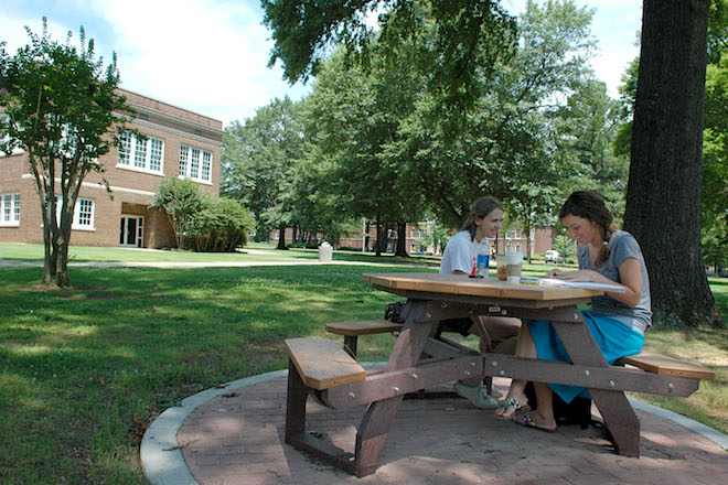 A pair of students study outside at the University of Central Arkansas in Conway. (File photo)
