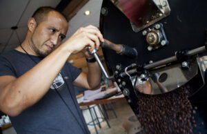 Geovanni Leiva, co-founder of Leiva&rsquo;s Coffee, roasts a batch of coffee beans. | (Photo by Wil Chandler)