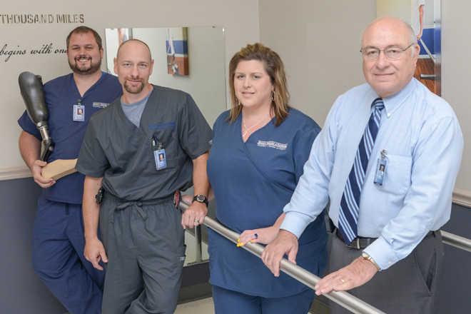 Chris, from left, Mike, Tonya and Gary Horton work at helping amputees and patients suffering from scoliosis and other disorders live a more active life. | (Photo by Mauren Kennedy)