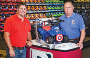 Rodney Redman, president and chief operating officer, stands with Mel Redman, chairman and chief executive officer, in Redman & Associates’ home office.  The CEO has  weathered a lawsuit and bankruptcy. | (Photo by Beth Hall)