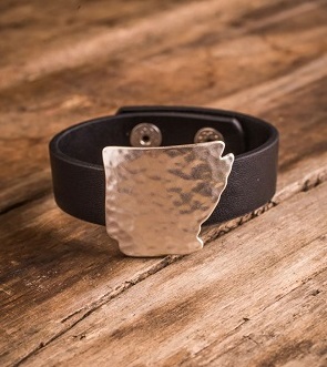 An example of the Bourbon & Boots by Dillard's line: a leather cuff with a silver plate fashioned in the shape of Arkansas.&nbsp;
