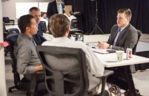 Spencer Jones (right) of ARK Challenge startup Jones Innovative Medical Solutions meets with mentors from Gravity Ventures Arkansas.