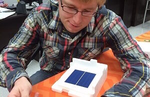 Picasolar CEO Douglas Hutchings displays one of the solar cells his company is developing as part of a federal intitiative.