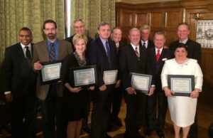 Posing for a group shot after Wednesdfay's announcement of the ARA Fellows program were (from left) UAPB chancellor Laurence Alexander, ARA Fellow Trace Peterson, ARA Fellow Laura James, UAMS chancellor Dan Rahn, ARA Fellow Alexandru Biris, UALR chancellor Joel Anderson, ARA Fellow Alan Mantooth, Gov. Mike Beebe, UA chancellor David Gearhart, ARA Fellow&nbsp;Argelia Lorence and ASU chancellor Tim Hudson.