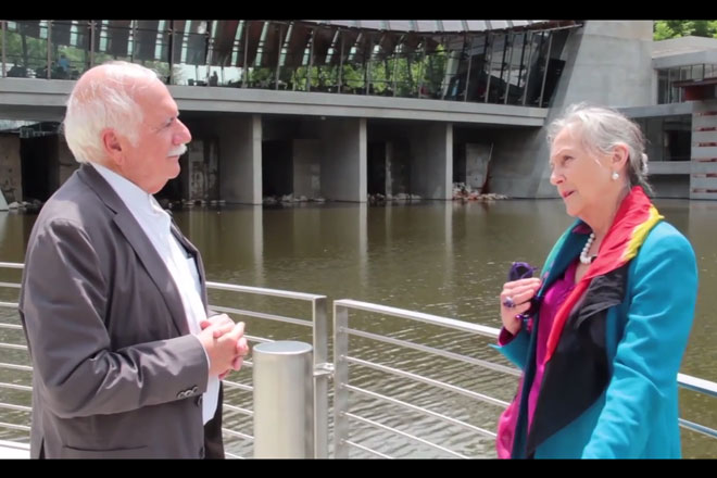 Architect Moshe Safdie discusses his vision of Crystal Bridges Museum of American Art with its founder, Alice Walton. | (Screenshot courtesy of the Crystal Bridges YouTube channel.)