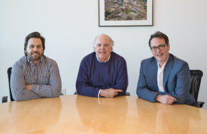 Chris Moses, left, and brother, Jamie, with their father, Jimmy, the founder of Moses Tucker Real Estate. Jimmy Moses&rsquo; partner, Rett Tucker, says they&rsquo;re both interested in planning for the future. | (Photo by Jason Burt)