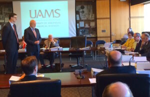 Tyson Foods Inc. Chairman John Tyson (standing, right) meets with the University of Arkansas board of trustees Wednesday at UAMS in Little Rock.