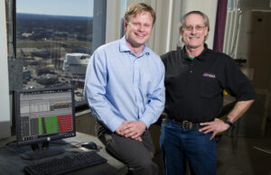 Paul James of Curtis Stout and Carl Jones from Union Plaza by the computer used to program the lights. One of the LEDs is visible outside the window.