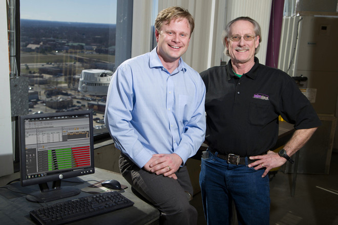 Paul James of Curtis Stout and Carl Jones from Union Plaza by the computer used to program the lights. One of the LEDs is visible outside the window.
