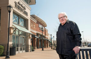 Bruce Burrow poses with his retailing baby, The Mall at Turtle Creek.  Financial setbacks led to a sale of the landmark Jonesboro project he long envisioned, but the mall remains a source of pride.