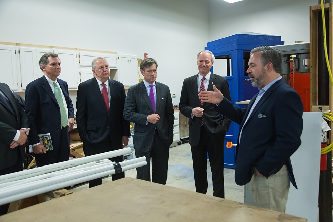 Joel Gordon (right), director of the Launch Pad maker space at the Innovation Hub, shows off his space following Monday's announcement to (from left) U.S. Rep. French Hill, North Little Rock Mayor Joe Smith; Matt Erskine of the U.S. Economic Development Administration and Gov. Asa Hutchinson. The Hub is hosting the Arkansas Manufacturing Innovation Summit on Wednesday and Thursday.