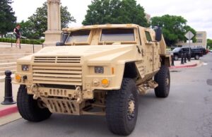 Gov. Asa Hutchinson and officials with Lockheed Martin show off the company's Joint Light Tactical Vehicle.