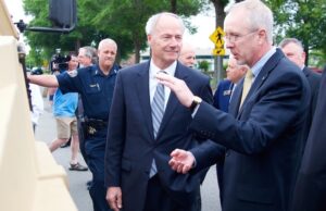 Gov. Asa Hutchinson talks to Scott Greene, Lockheed Martins' vice president of ground vehicles.