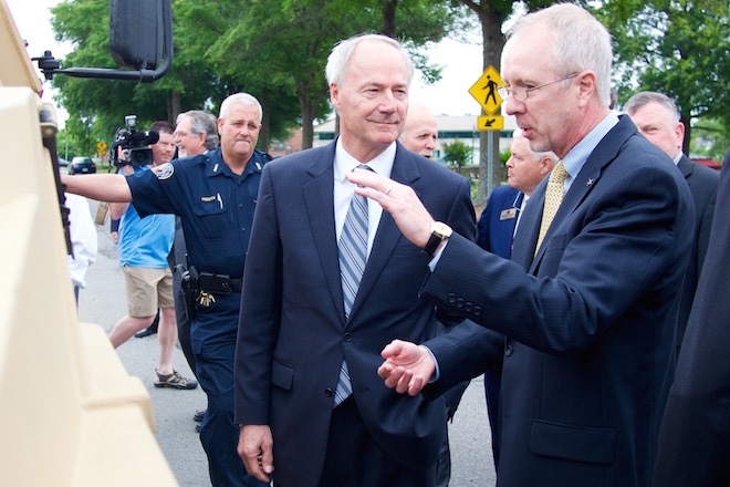 Gov. Asa Hutchinson talks to Scott Greene, Lockheed Martins' vice president of ground vehicles.