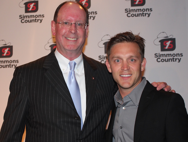 Simmons CEO George Makris (left) and country music artist Justin Moore announced a new advertising campaign at the bank's annual shareholders meeting.
