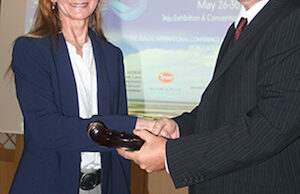 Dr. Rebecca Lochmann, incoming president of the World Aquaculture Society, is passed the gavel by Graham Mair, outgoing president, during the society&rsquo;s conference held in May in Jeju, South Korea.