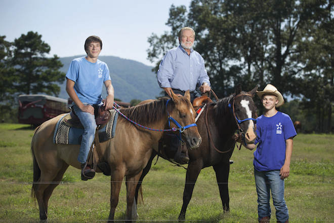 Larry Stone with kids who live on one of the Arkansas Sheriffs' Youth Ranches, where they have responsiblities like taking care of the animals and helping with normal household chores in the homes where they live with foster parents.