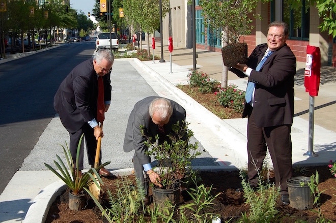 From left to right: Randy Young of the Pollution Control and Ecology Commission; Ron Curry, administrator of the EPA's Region 6; and Little Rock Mayor Mark Stodola plant the final shrubs in the streetscape.