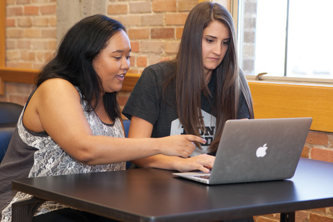 Iron Yard graduate Jacklyn Carroll, left, and Mary Dunlap, director of the Iron Yard’s Little Rock campus.