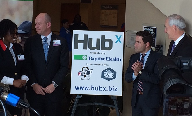 Unveiling the new HubX logo on Friday were (from left) Baptist Health's Grejuana Dennis, Baptist Health CEO Troy Wells, Innovation Hub Director Warwick Sabin and Gov. Asa Hutchinson.