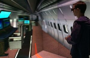 Carsten Neumann, a senior research scientist with the Emerging Analytics Center at UALR, demonstrates a virtual reality program in which he places equipment on a military aircraft.