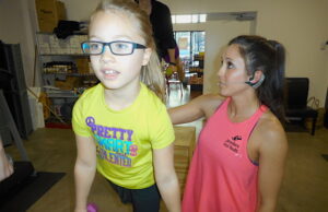 Ava Everhart, 7, of Jonesboro works out&nbsp;with Total Health owner Rose Hankins.