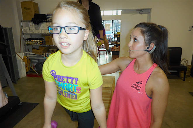 Ava Everhart, 7, of Jonesboro works out&nbsp;with Total Health owner Rose Hankins.