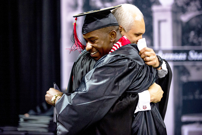 Arkansas State University Athletic Director Terry Mohajir hugging Charleston Girley, an A-State football player who benefited from the Red Wolves Leadership Academy.