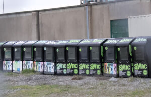 Sync newspaper boxes sit empty in a downtown Little Rock lot.